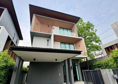 Three-story modern house with carport and garden