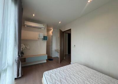 Bedroom with a window, bed, air conditioner, and built-in shelving