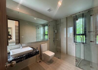 Modern bathroom with glass shower and large mirror