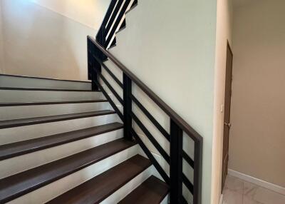 Modern staircase with dark wood steps and minimalist railing