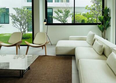 Modern living room with large windows and garden view