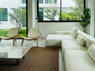 Modern living room with large windows and garden view