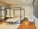 Modern bedroom with a four-poster bed and large mirror