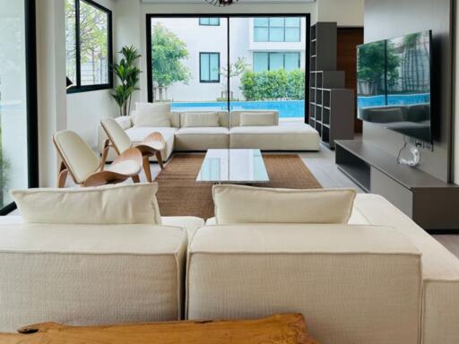 Modern living room with large windows and pool view