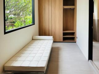 Minimalist bedroom with wardrobe and bed