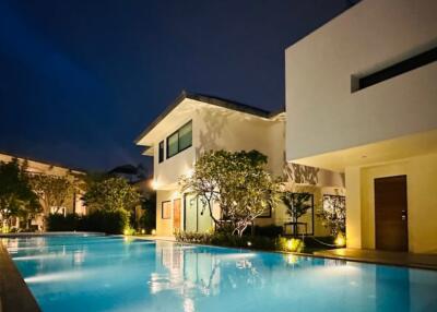 Modern house with illuminated swimming pool at night