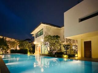 Modern house with illuminated swimming pool at night