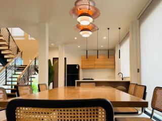 Modern kitchen with dining area and stylish lighting