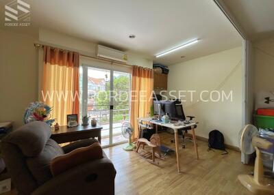 Living space with a desk and sliding glass doors