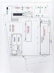 Property layout showing various areas such as workshops, parking, and green areas