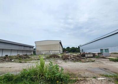 Vacant land area with surrounding warehouse buildings