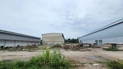 Vacant land area with surrounding warehouse buildings