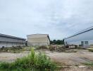 Vacant land area with surrounding warehouse buildings