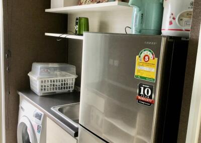 Modern laundry room with washing machine and a fridge