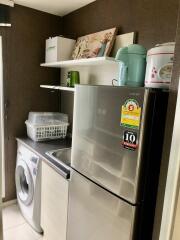 Modern laundry room with washing machine and a fridge