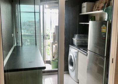 Modern kitchen area with appliances and storage