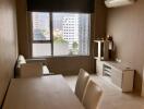 Modern living room with dining table, sofa, air conditioner, and city view window