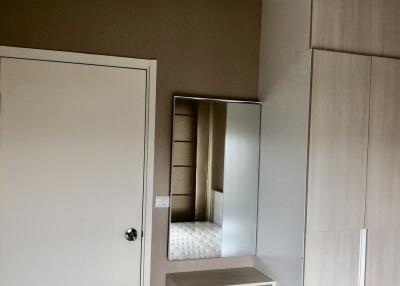 Modern bedroom with mirror and wardrobe