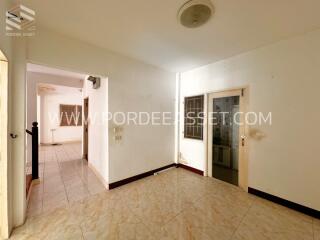 Main living area with tile flooring and a door to another room