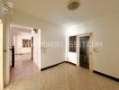 Main living area with tile flooring and a door to another room