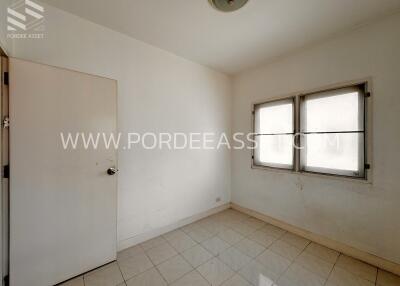 Empty room with tiled floor and two windows