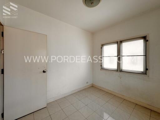 Empty room with tiled floor and two windows