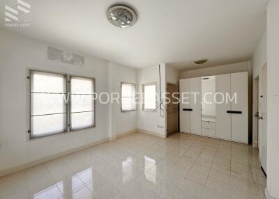 Spacious bedroom with built-in wardrobes and large windows