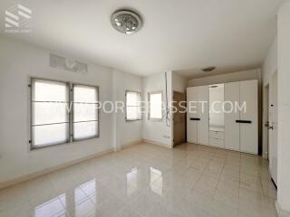 Spacious bedroom with built-in wardrobes and large windows