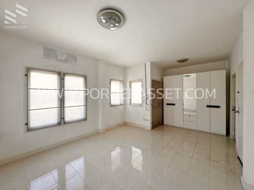 Spacious bedroom with built-in wardrobes and large windows