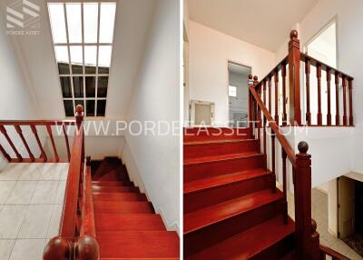 Staircase with red wooden railing