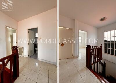 Staircase and hallway with bathroom and tiled floor