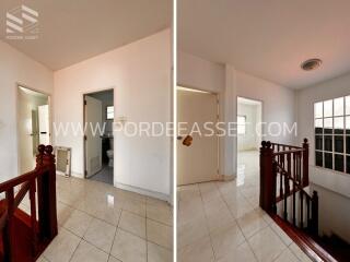 Staircase and hallway with bathroom and tiled floor