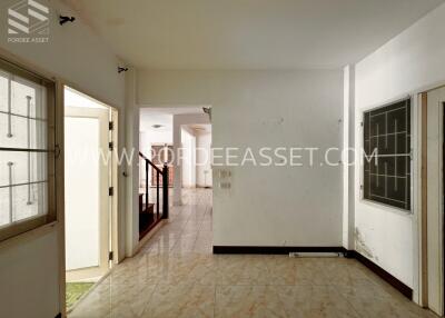 Living area with tile flooring and open plan design featuring adjacent rooms