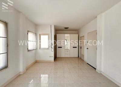 Bright and spacious bedroom with tiled floor and built-in closets