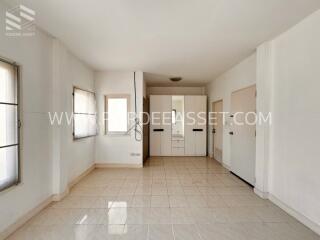 Bright and spacious bedroom with tiled floor and built-in closets