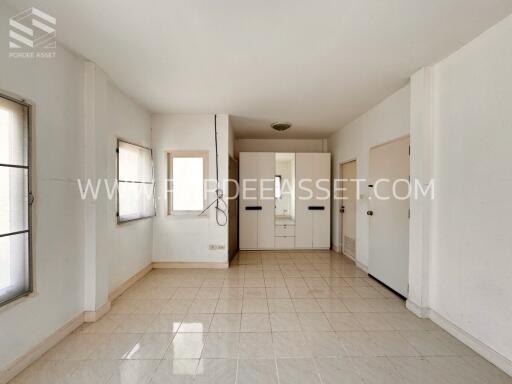 Bright and spacious bedroom with tiled floor and built-in closets