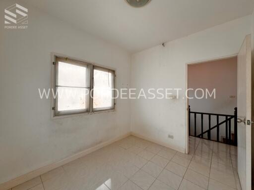 Empty bedroom with tiled floor and a window