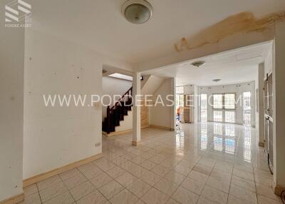 Spacious interior area with tiled floor and staircase