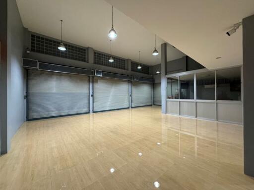 Spacious open area with polished floors and large windows