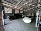 Spacious garage with three cars parked