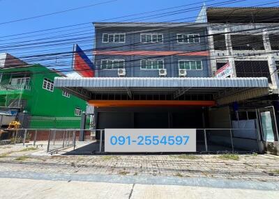 Street view of a commercial building with a large signboard