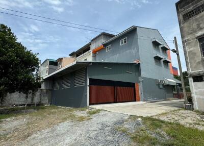 Exterior view of a multi-story residential building with a large garage