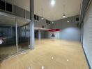 Open spacious commercial area with glass partitions and roller shutter door