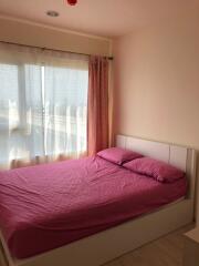 Bedroom with pink bedding and large window