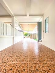 Covered outdoor patio with tiled flooring