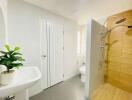 Modern bathroom with sink, shower, toilet, and indoor plant