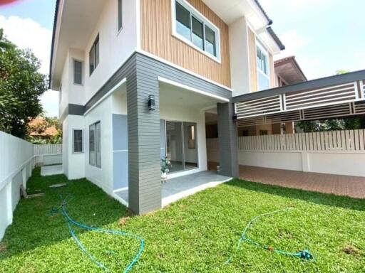 Exterior view of a two-story house with a lawn