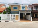 Exterior view of a modern two-story house with a carport