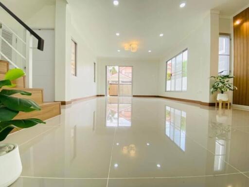 spacious well-lit living room with tiled floors and large windows