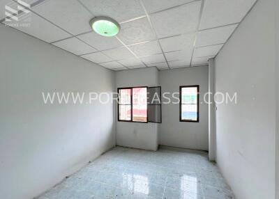 Empty bedroom with tiled floor and windows